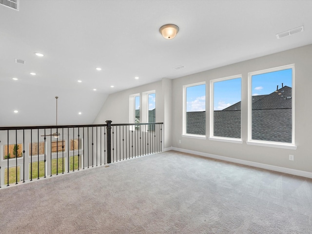 empty room featuring light carpet, recessed lighting, visible vents, and baseboards