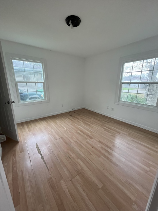 interior space with light wood finished floors and baseboards