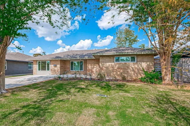 ranch-style house with brick siding, a patio, and a front lawn