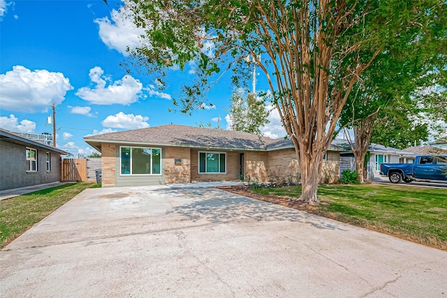 ranch-style house featuring brick siding and a front lawn