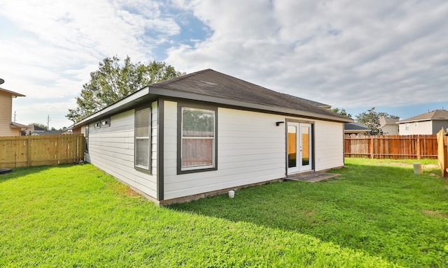 back of property with a yard and a fenced backyard