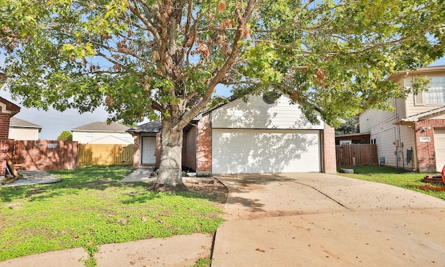 view of front of house featuring a garage, brick siding, fence, driveway, and a front lawn