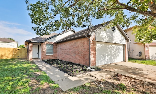 view of property exterior featuring concrete driveway, an attached garage, fence, a yard, and brick siding