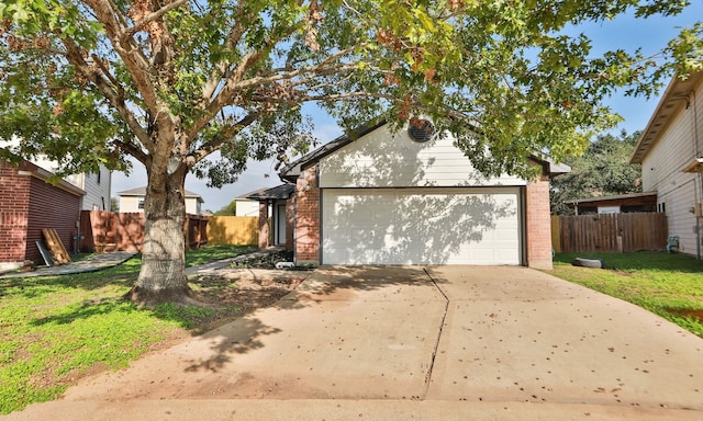 view of front of house with a garage, brick siding, fence, concrete driveway, and a front yard