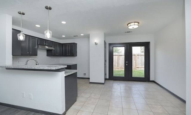 kitchen featuring pendant lighting, french doors, visible vents, dark cabinetry, and a peninsula