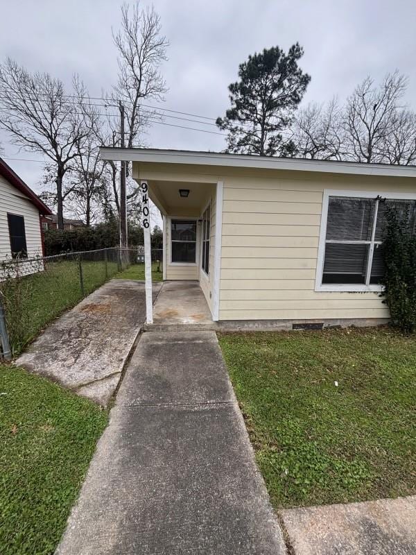 exterior space featuring crawl space, a patio area, a yard, and fence