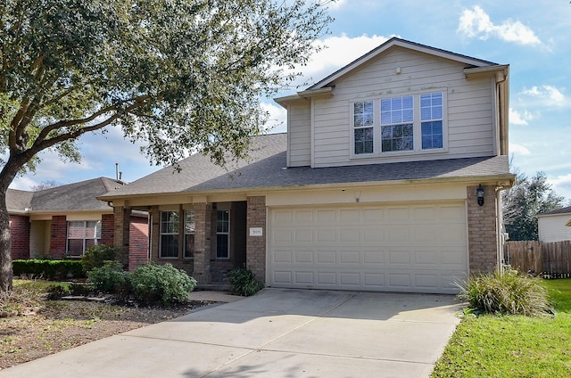 traditional home with driveway, brick siding, roof with shingles, and an attached garage