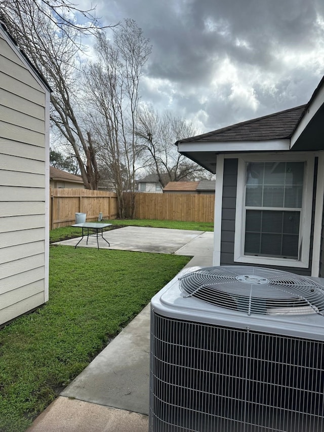 details featuring a shingled roof, cooling unit, and fence