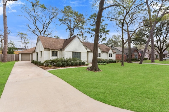 view of front of property with a residential view, roof with shingles, fence, a front lawn, and brick siding