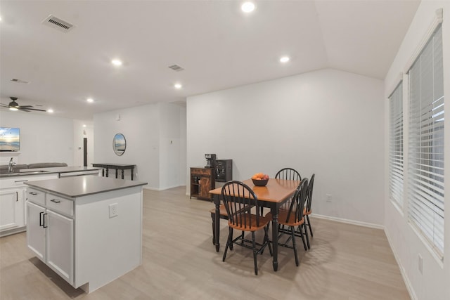 dining area with light wood finished floors, recessed lighting, visible vents, vaulted ceiling, and baseboards