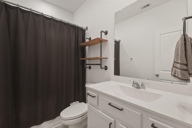 bathroom with toilet, visible vents, and vanity