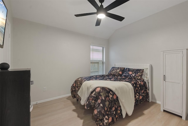 bedroom featuring lofted ceiling, ceiling fan, light wood-type flooring, and baseboards