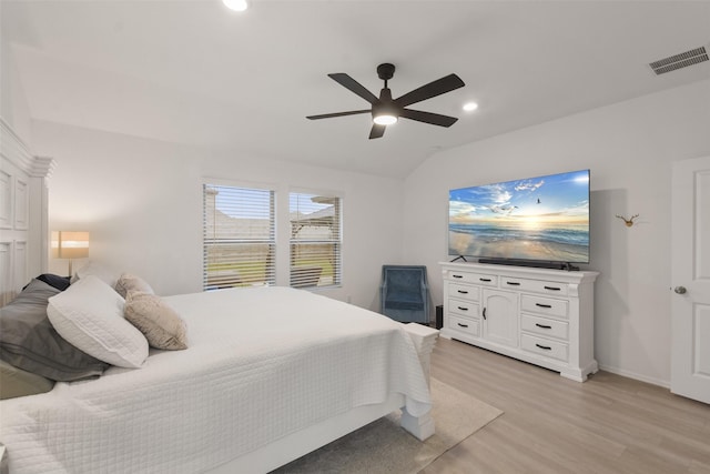 bedroom with ceiling fan, recessed lighting, visible vents, light wood-style floors, and vaulted ceiling