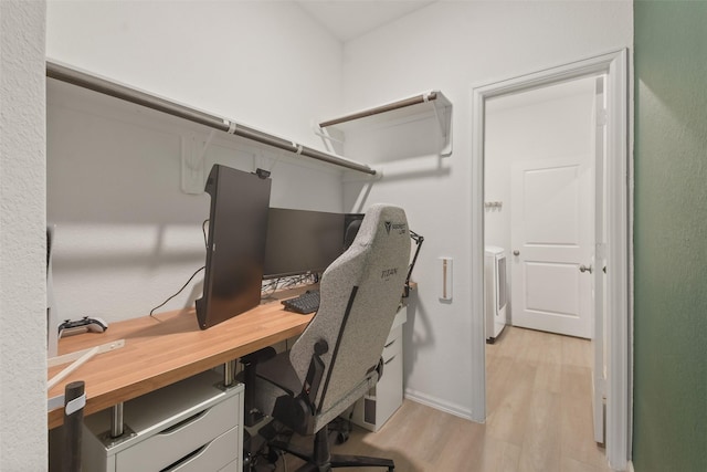 home office featuring washer / dryer and light wood finished floors