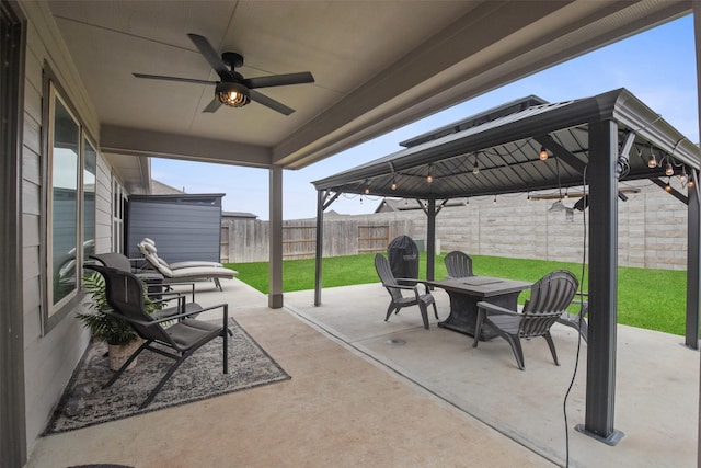 view of patio / terrace featuring a ceiling fan, a fenced backyard, and a gazebo