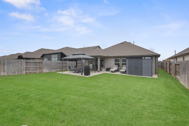 back of property with a gazebo, a yard, a patio, and a fenced backyard