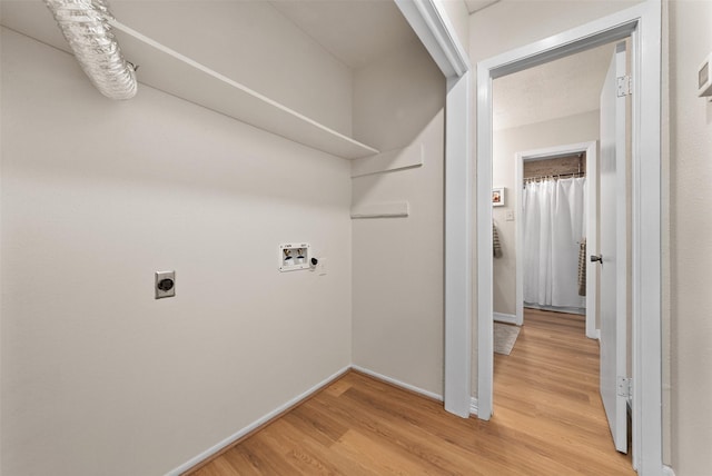 laundry area with hookup for a washing machine, hookup for an electric dryer, laundry area, wood finished floors, and baseboards