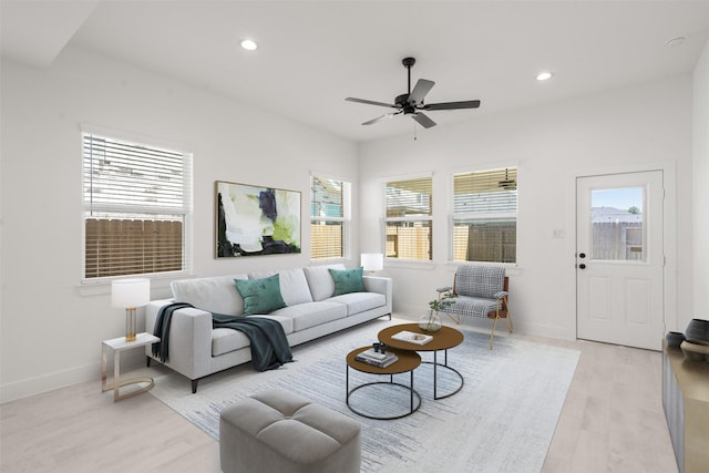 living room with recessed lighting, light wood-type flooring, and a healthy amount of sunlight