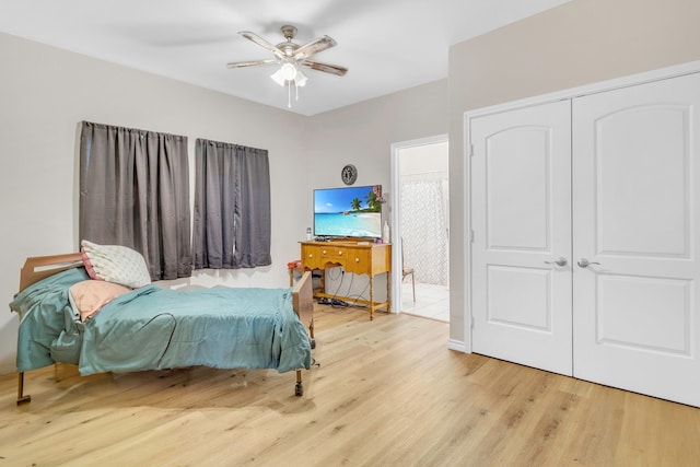 bedroom featuring ceiling fan, a closet, and wood finished floors
