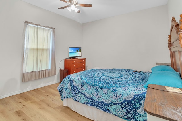 bedroom with baseboards, ceiling fan, and wood finished floors