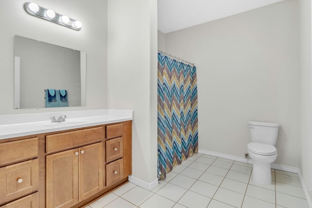 bathroom featuring vanity, toilet, tile patterned floors, baseboards, and curtained shower