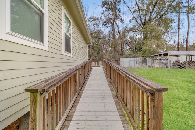 view of home's exterior with a lawn, fence, and a wooden deck