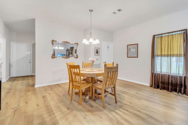 dining area featuring baseboards, visible vents, an inviting chandelier, and light wood-style floors
