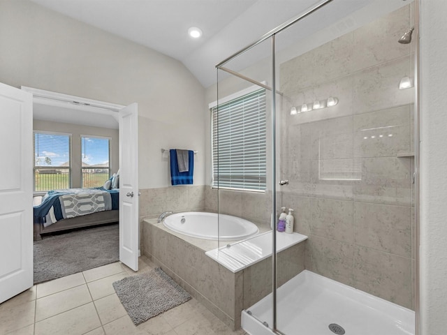 full bathroom with lofted ceiling, connected bathroom, a shower stall, a bath, and tile patterned floors