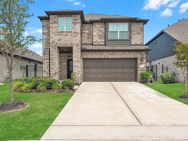 view of front of property with brick siding, roof with shingles, concrete driveway, an attached garage, and a front yard