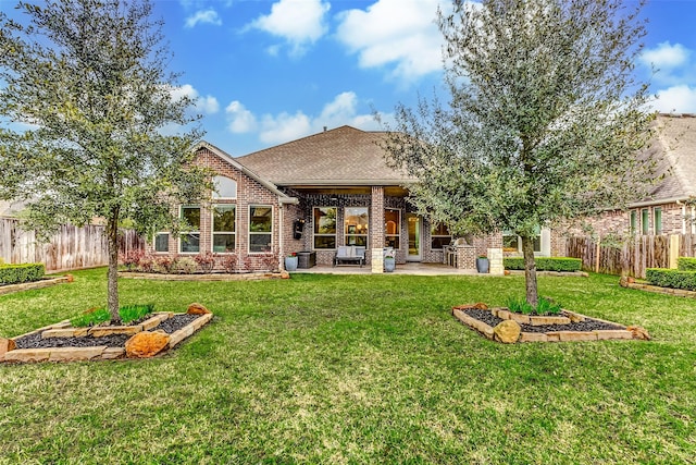 rear view of property featuring a patio area, a fenced backyard, and a lawn