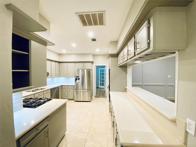 kitchen featuring stainless steel appliances, light countertops, visible vents, and light tile patterned floors