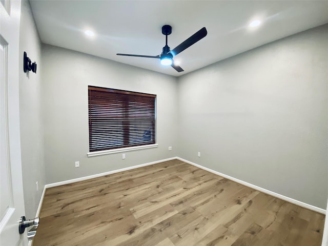 spare room featuring light wood-style floors, baseboards, a ceiling fan, and recessed lighting