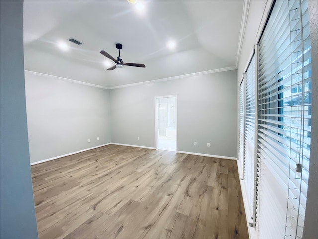 empty room with visible vents, baseboards, light wood-style flooring, ceiling fan, and ornamental molding