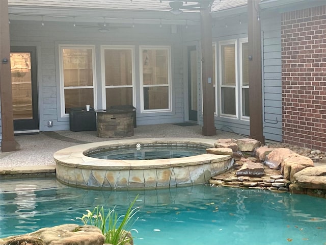 pool featuring ceiling fan and an in ground hot tub