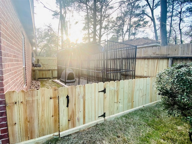 exterior space featuring a fenced backyard and a gate