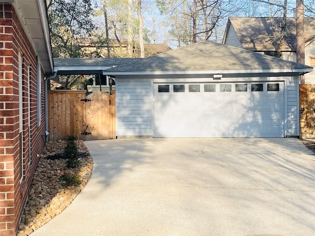 detached garage featuring fence