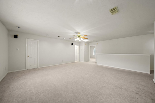 spare room with visible vents, carpet, a ceiling fan, and baseboards