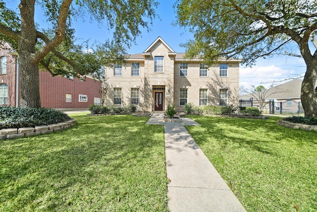 view of front of home featuring brick siding and a front lawn