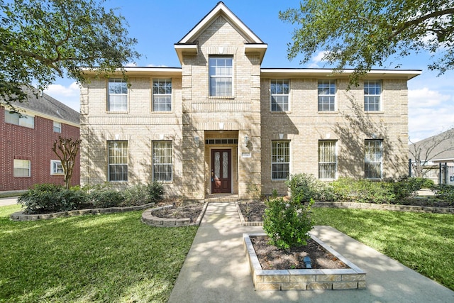 view of front of home featuring a front yard and brick siding