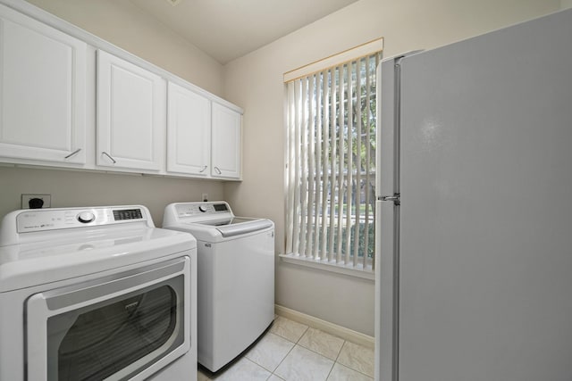16942 Laguna Springs Dr, Houston, TX 77095 - laundry room with independent washer and dryer, cabinet space, baseboards, and light tile patterned floors