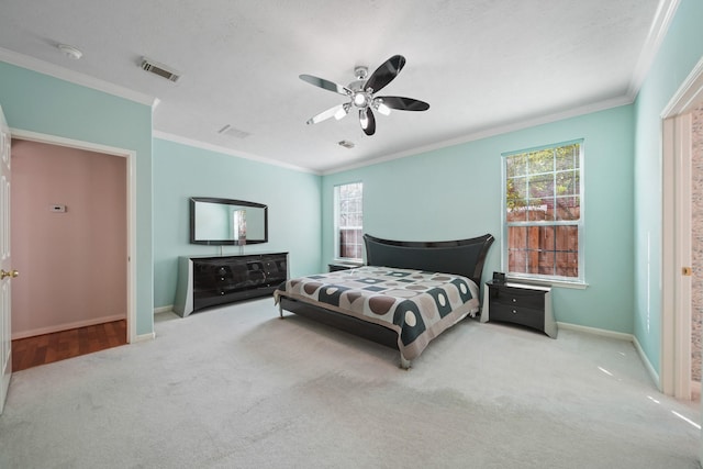 bedroom with light colored carpet, visible vents, ornamental molding, a ceiling fan, and baseboards