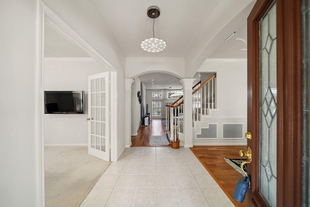 16942 Laguna Springs Dr, Houston, TX 77095 - foyer entrance featuring ornate columns, arched walkways, french doors, tile patterned floors, and baseboards
