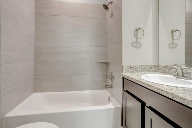 bathroom with toilet, vanity, and bathing tub / shower combination