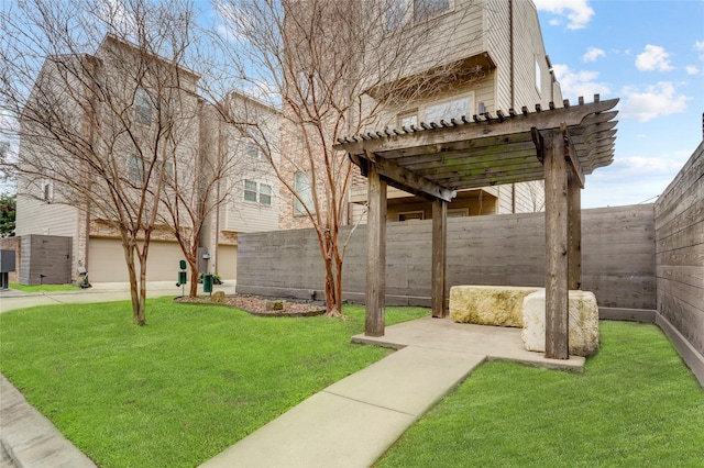 view of yard with a garage, fence, and a pergola