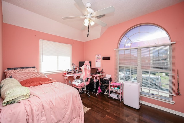 bedroom with lofted ceiling, baseboards, dark wood finished floors, and a ceiling fan