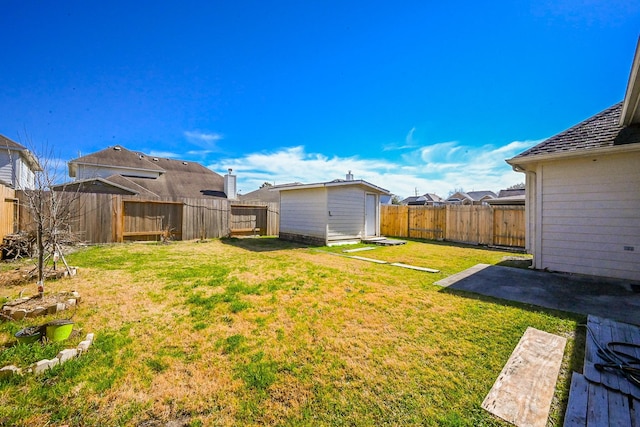 view of yard featuring an outbuilding, a fenced backyard, a patio, and a storage shed