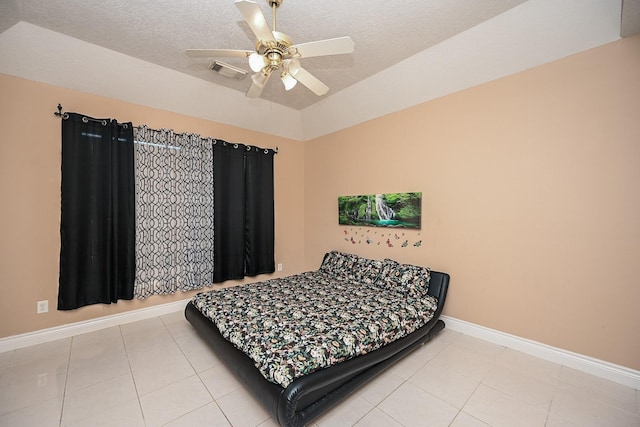 bedroom with light tile patterned floors, baseboards, visible vents, and a textured ceiling