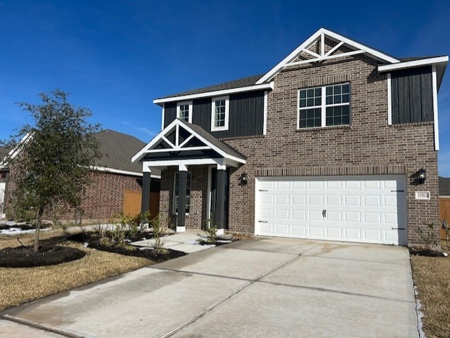 view of front of home featuring a garage, brick siding, and driveway