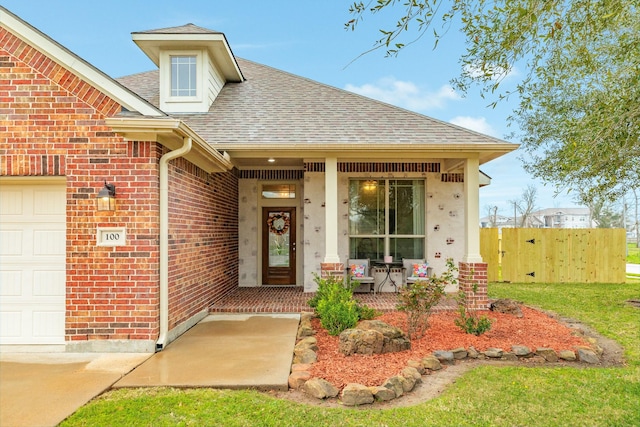 doorway to property with a garage, roof with shingles, fence, a porch, and brick siding