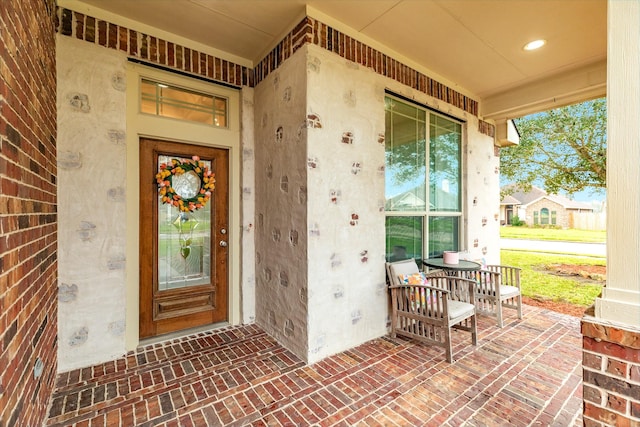 property entrance featuring brick siding